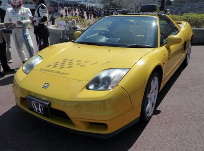 Yellow sports coupe with hood graphics and clear headlights