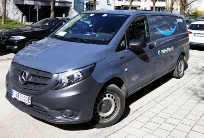 Electric long wheelbase delivery van with Amazon Prime branding and 100% electric badge