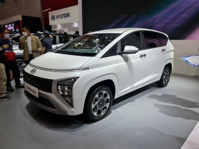 Front view of a modern white SUV with split headlights and bold grille