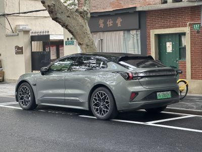 Rear side view of a modern electric sedan with alloy wheels and sleek design.