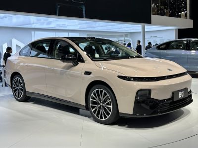 Sleek electric sedan with LED light bar and aerodynamic shape