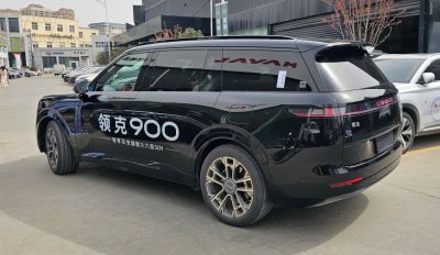 Rear side profile of large SUV with modern taillights and alloy wheels