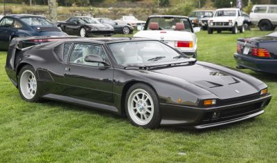 Black sports coupe with aerodynamic design and white interior.