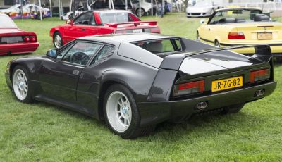 Rear side view of a 1990 sports coupe with angular rear and dual exhausts