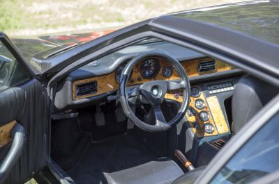 Wood grain dashboard and steering wheel with vintage gauges
