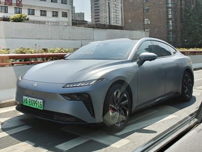 Electric sedan with sharp LED headlights and alloy wheels on urban road