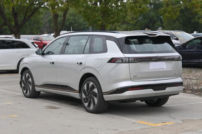 Sleek rear and side view of modern electric SUV with aerodynamic wheels and futuristic lighting