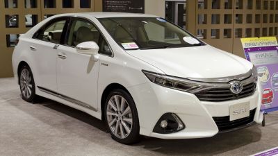 White sedan with sleek front grille and integrated fog lights