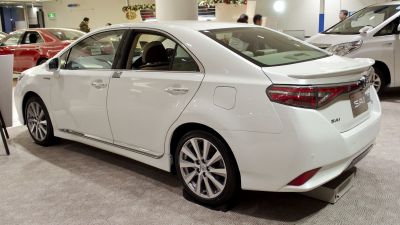 Rear side view of white sedan with distinctive rear lights and alloy wheels