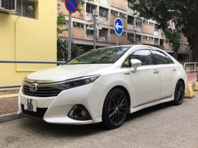 Front three-quarter view with sleek headlights and black multi-spoke alloy wheels