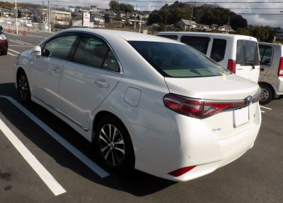 White sedan rear and side view with modern taillights and alloy wheels