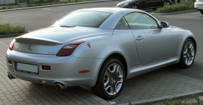 Silver two-door coupe with rear spoiler and dual exhausts