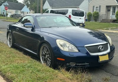 Front side view of convertible coupe with sleek headlights and sporty wheels