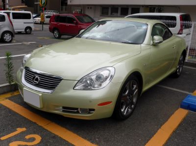 Front view of luxury coupe with distinctive headlights and alloy wheels