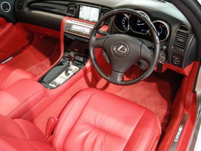 Red leather seats and dashboard with navigation display and automatic gear shift