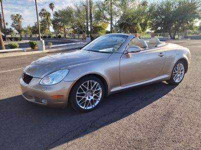 Convertible luxury coupe with alloy wheels and beige leather interior