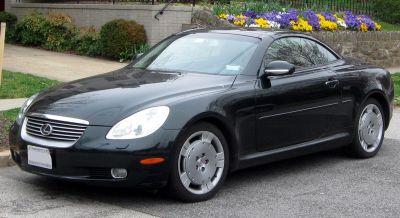 Sleek luxury coupe front-side view with distinctive grille and smooth body lines