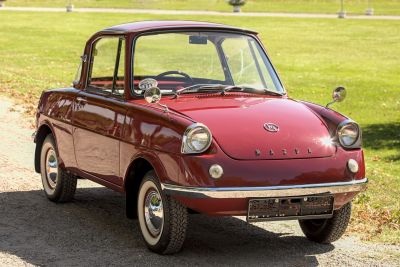 Compact economy car with round headlights and chrome bumpers