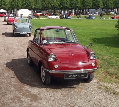 Red microcar with rounded headlights and chrome bumper