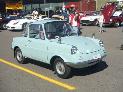 Vintage compact microcar with rounded headlamps and classic design