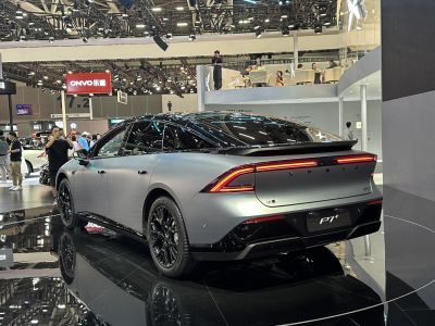 Rear view of sleek sedan with LED light bar and matte finish