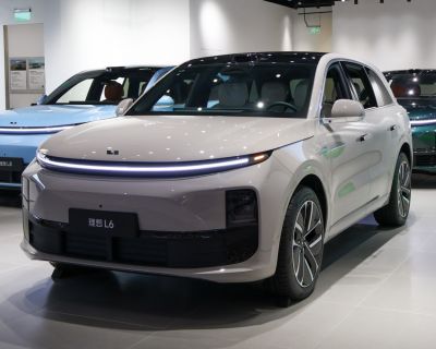 Front view of modern SUV with LED headlight strip and aerodynamic design