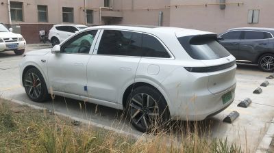 Rear-side profile of a modern electric SUV with alloy wheels