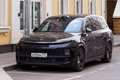 Sleek black electric SUV with panoramic glass roof and innovative front lighting design