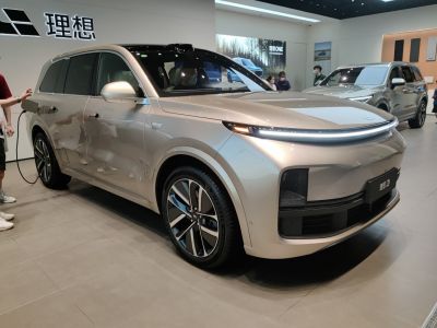 Front side view of an electric SUV with LED headlights and sleek aerodynamic lines