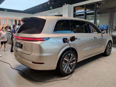 Electric SUV rear charging port with LED light bar and modern wheels