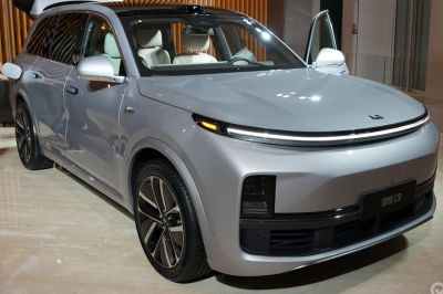 Front view of electric SUV with LED lighting and aerodynamic design.
