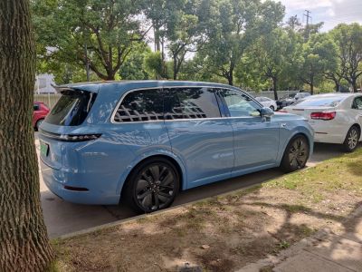 Blue electric SUV side view with tinted windows and aerodynamic styling