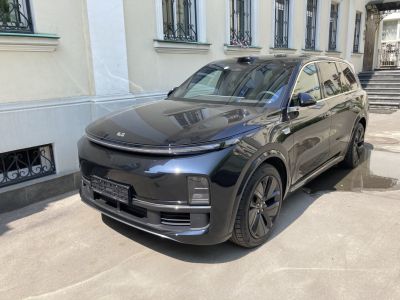 Front and side of sleek black electric SUV with LED strip lighting