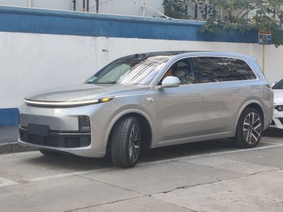 Front and side view of a silver modern electric SUV