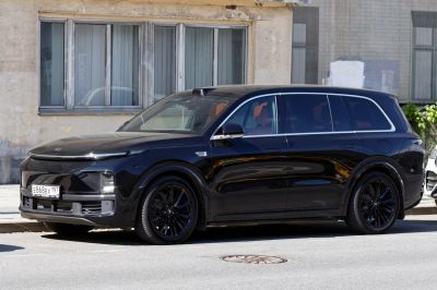 Black electric luxury SUV with panoramic roof and sleek side profile