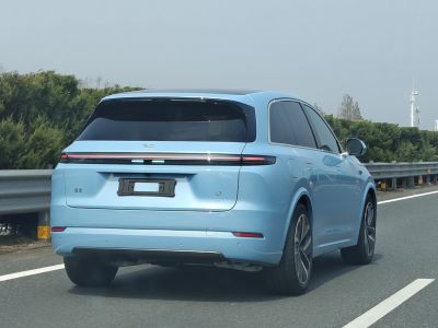 Rear view with LED light bar and aerodynamic shape on a blue SUV