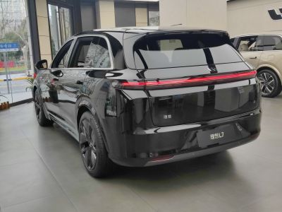 Sleek black SUV rear with continuous LED tail light strip and aerodynamic shape