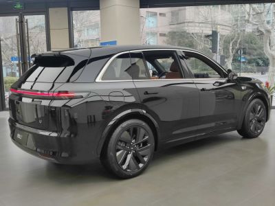 Rear and side view of sleek black SUV with modern taillights and black wheels