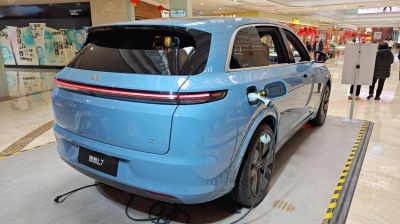 Blue electric SUV rear view with LED taillight and charging port