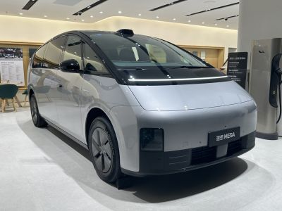 Sleek electric minivan with digital strip front lighting and aerodynamic design