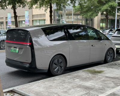 Sleek electric minivan rear and side profile with LED taillight strip and aerodynamic design