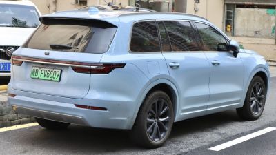 SUV rear and side view with continuous tail lights and tinted windows