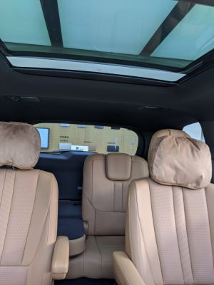 Beige leather seats with armrest and panoramic sunroof interior