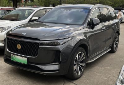 Luxury SUV with distinctive front grille and side step in grey