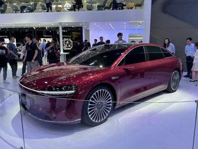 Sleek electric luxury sedan with futuristic design and intricate alloy wheels