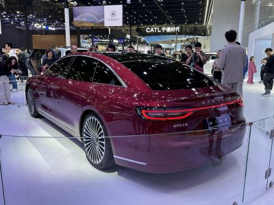 Luxury sedan rear with LED continuous taillights and aerodynamic roofline
