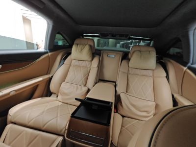 Plush tan leather rear seats with diamond stitching and pillows