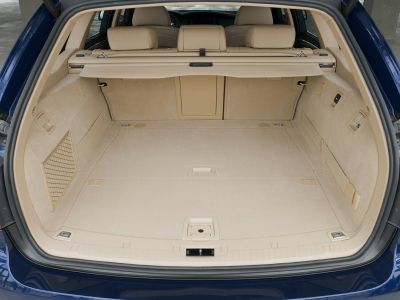 Spacious beige cargo area with organized storage compartments and covers