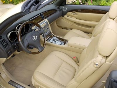 Beige leather seats with wood trim dashboard and steering wheel