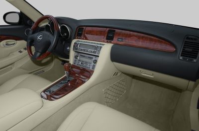 Luxury beige leather interior with wood trim dashboard and automatic gear shift